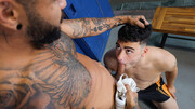 Tattooed Latino having fun with a submissive pale lad