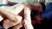 Tattooed man with a hairy body banging a submissive fella
