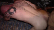 Tattooed man in the middle of two girthy dongs in a threesome