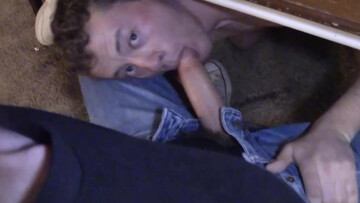 He is hiding below the table to give his partner a BJ