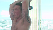 Tattooed man works out with weights and a submissive fella