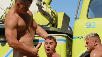 Hunks are having a threesome next to the big vehicle