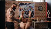 A tied lad is getting penetrated by a tattooed bear