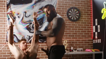 A tied lad is getting penetrated by a tattooed bear
