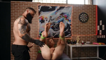 A tied lad is getting penetrated by a tattooed bear