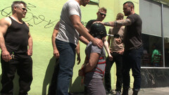 Muscular man is tied up and rocked by a bunch of studs