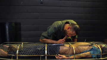 Caged male slave lets master feast with his erect cock