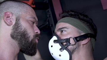 The jock is playing with the masked, submissive twink