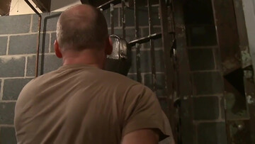 Balding man puts a mask on his submissive playboy