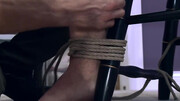 Tied man is showing his uncircumcised cock while sitting