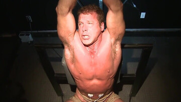 Moaning and trying not to show the pain in a BDSM setting