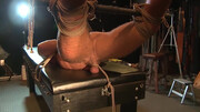Tied up man is in the room and the sadistic dom tests him