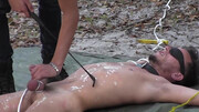 Kinky man is blindfolded and rocked in the woods