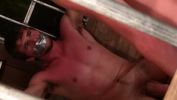 Caged male slave awaits his master for the ultimate sexual punishment