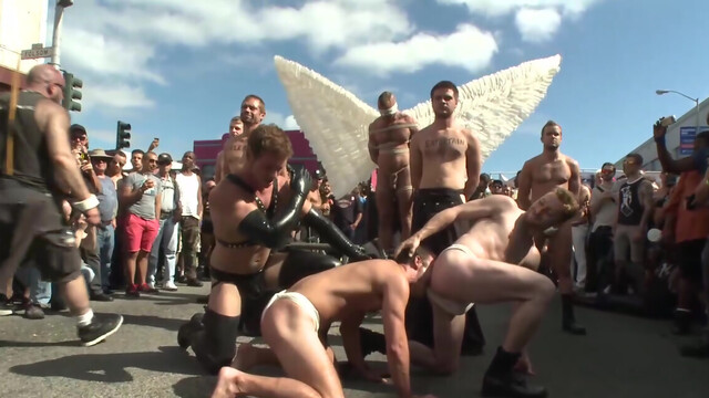 Submissive man lets his masters take advantage of him in public