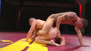 Muscular men make out in the ring in a rough wrestling play