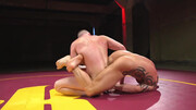Muscular men make out in the ring in a rough wrestling play