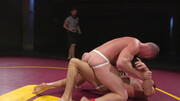 Muscular men make out in the ring in a rough wrestling play
