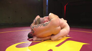 Muscular men make out in the ring in a rough wrestling play