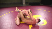 Muscular men make out in the ring in a rough wrestling play