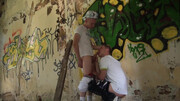 Two skinny dudes with fit bodies have fun under a bridge